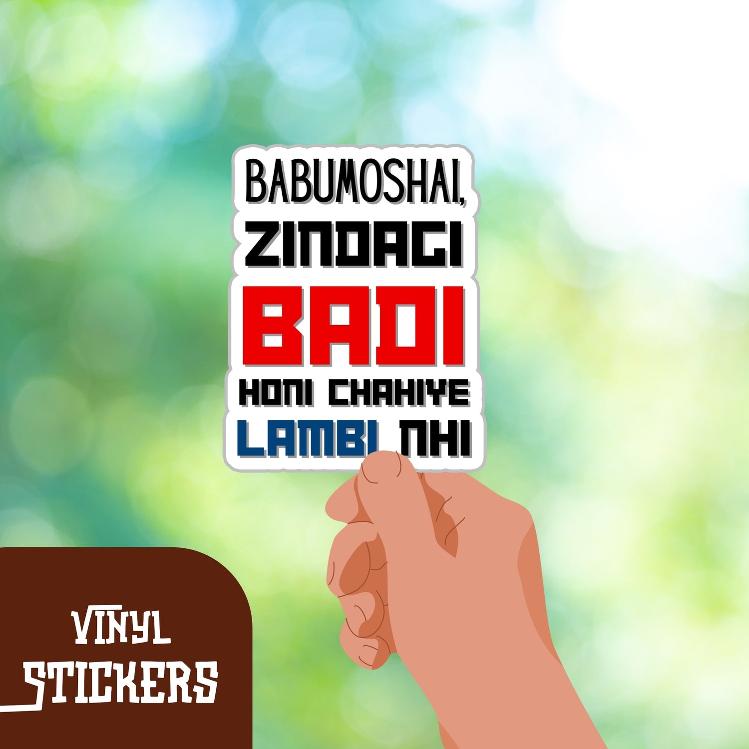 Hand holding a colorful vinyl sticker with text showcasing durable waterproof vinyl decals against a blurred green background
